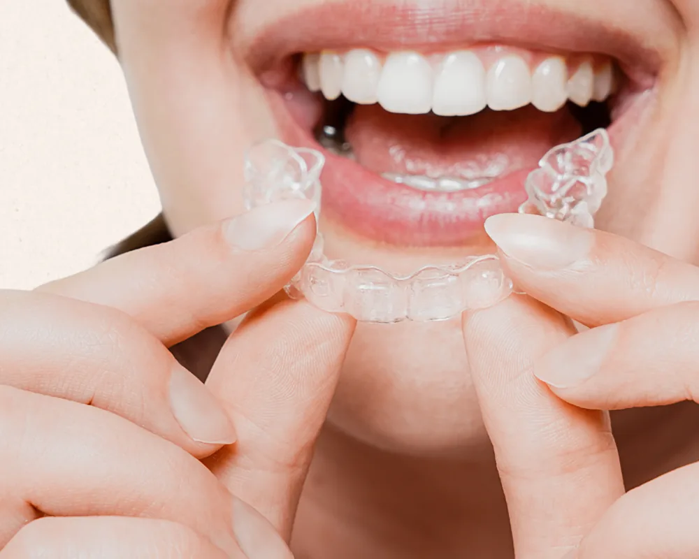 A person holding a clear orthodontic aligner